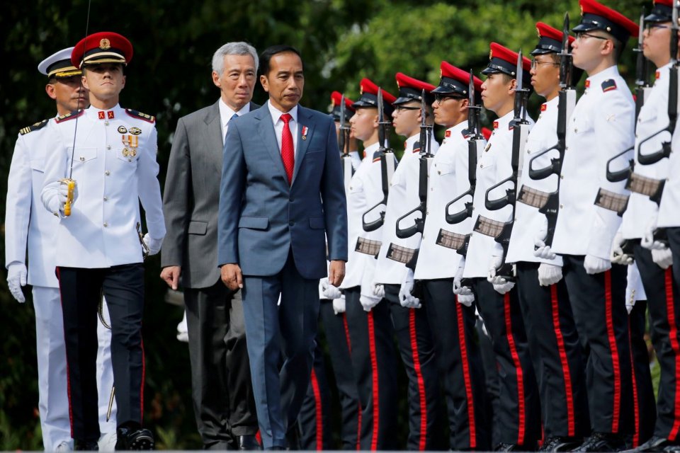 Presiden Joko Widodo (keempat kiri) didampingi PM Singapura Lee Hsien Loong (ketiga kiri), melakukan inspeksi pasukan, di Istana, di Singapura, Selasa (08/10/2019). 