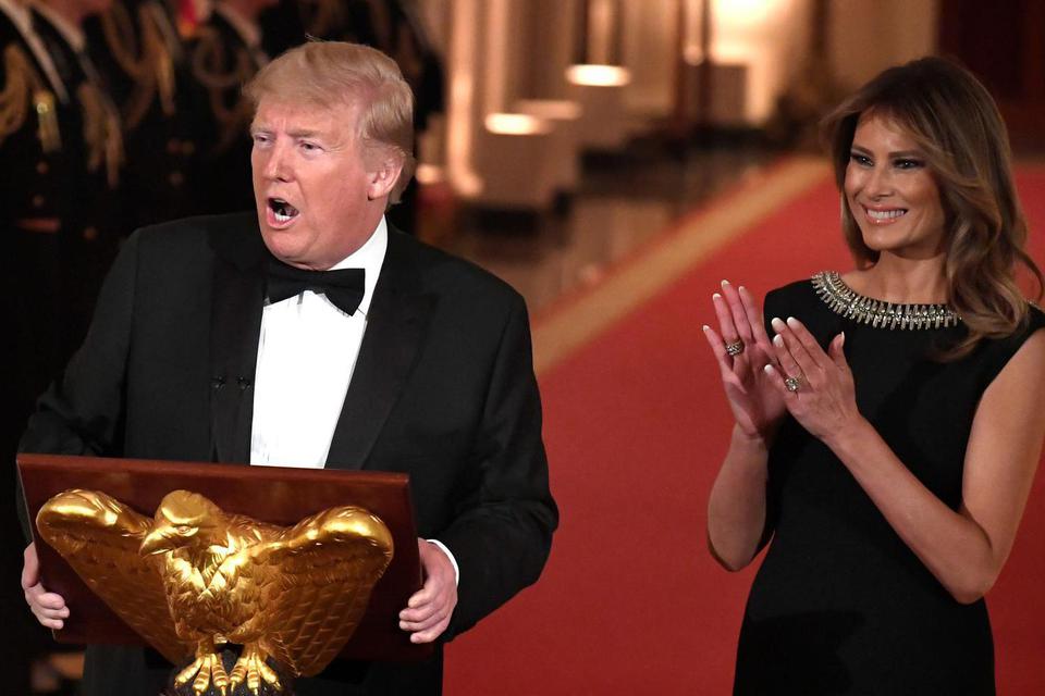 Presiden Amerika Serikat Donald Trump memberikan ucapan selamat datang saat Ibu Negara Melania Trump bertepuk tangan, saat Presiden menyelenggarakan Governors Ball di Ruang Timur Gedung Putih, Washington, DC, Amerika Serikat, Minggu (9/2/2020).