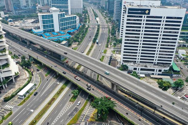 Foto aerial kendaraan melintas di kawasan Semanggi, Jakarta, Jumat (27/3/2020). Sejumlah ruas jalan utama ibu kota lebih lengang dibandingkan hari biasa karena sebagian perusahaan telah menerapkan bekerja dari rumah guna menekan penyebaran virus Corona at