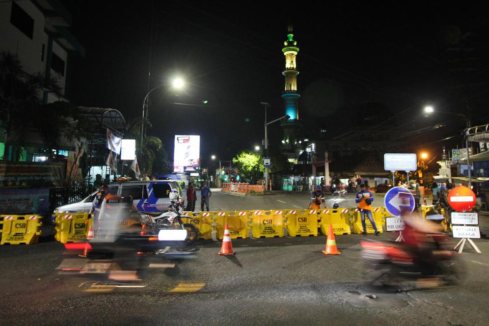 Petugas berjaga di Jalan Rungkut Menanggal yang ditutup untuk mencegah penularan corona di Surabaya, Jawa Timur, Kamis (4/6/2020). 
