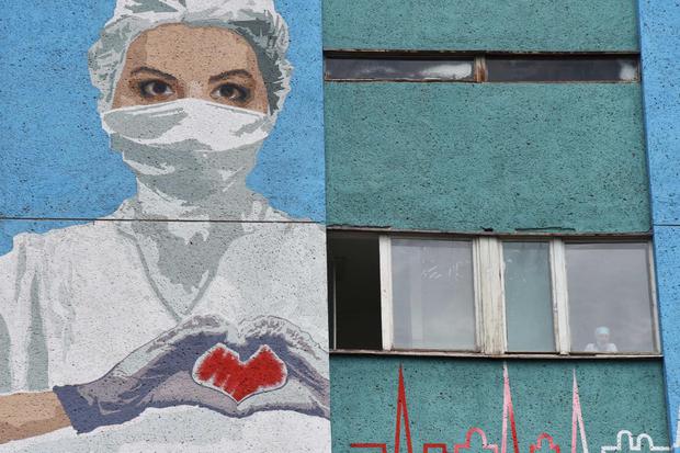 Mural bergambar petugas kesehatan terlihat di dinding Rumah Sakit Darurat Kota, ditengah wabah penyakit virus corona (COVID-19) di Lviv, Ukraina, Minggu (21/6/2020).