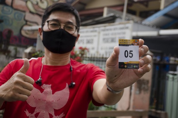 Seorang relawan menunjukkan nomor antrean uji klinis vaksin Covid-19 buatan Sinovac (Tiongkok) usai pemeriksaan kesehatan di Puskesmas Dago, Bandung, Jawa Barat, Selasa (11/8). 