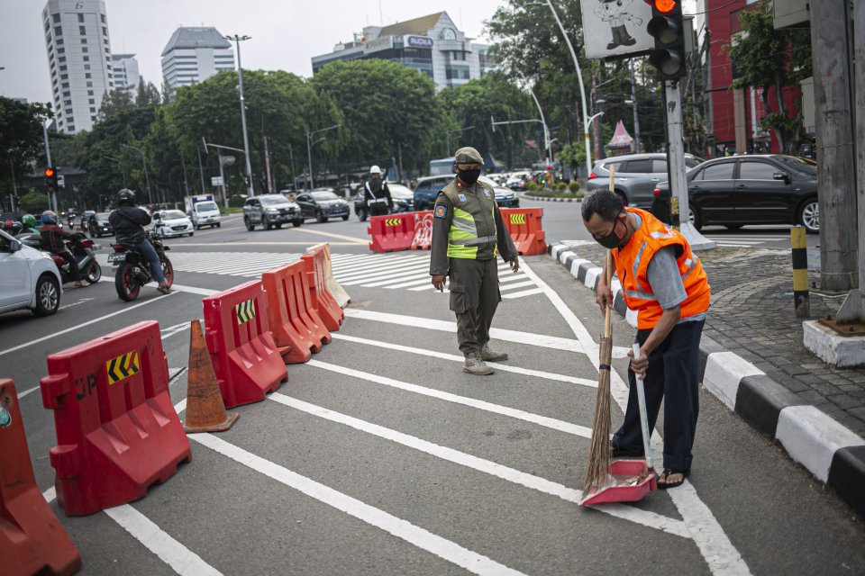 Warga pelanggar PSBB diberi sanksi menyapu jalan di Kawasan Tugu Tani, Jakarta Pusat, Senin (14/9/2020). Meski demikian, PSBB jilid II ini memiliki sejumlah aspek pembatasan yang berbeda bila dibandingkan dengan pelaksanaan yang dilakukan pada awal April.