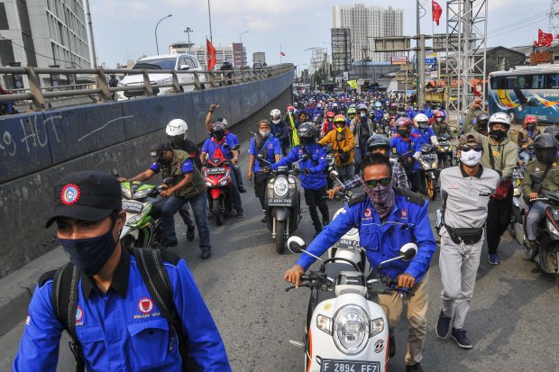 Sejumlah buruh dari berbagai aliansi menggelar aksi dorong motor di Jalan raya Cikarang-Cibarusah, Kabupaten Bekasi, Jawa Barat, Selasa (6/10/2020). Aksi tersebut sebagai kekecewaan buruh atas pengesahan Undang-Undang Cipta Kerja oleh DPR. 