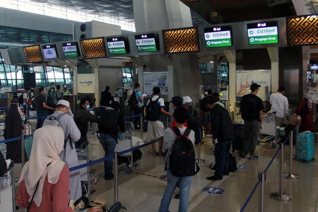 Calon penumpang antre untuk Òcheck inÓ, di Terminal 3 Bandara Soekarno Hatta, Tangerang, Banten, Senin (26/10/2020). Kementerian Perhubungan memprediksi kenaikan pergerakan penumpang pesawat mencapai 20 persen di masa libur panjang 28 Oktober hingga 1 N