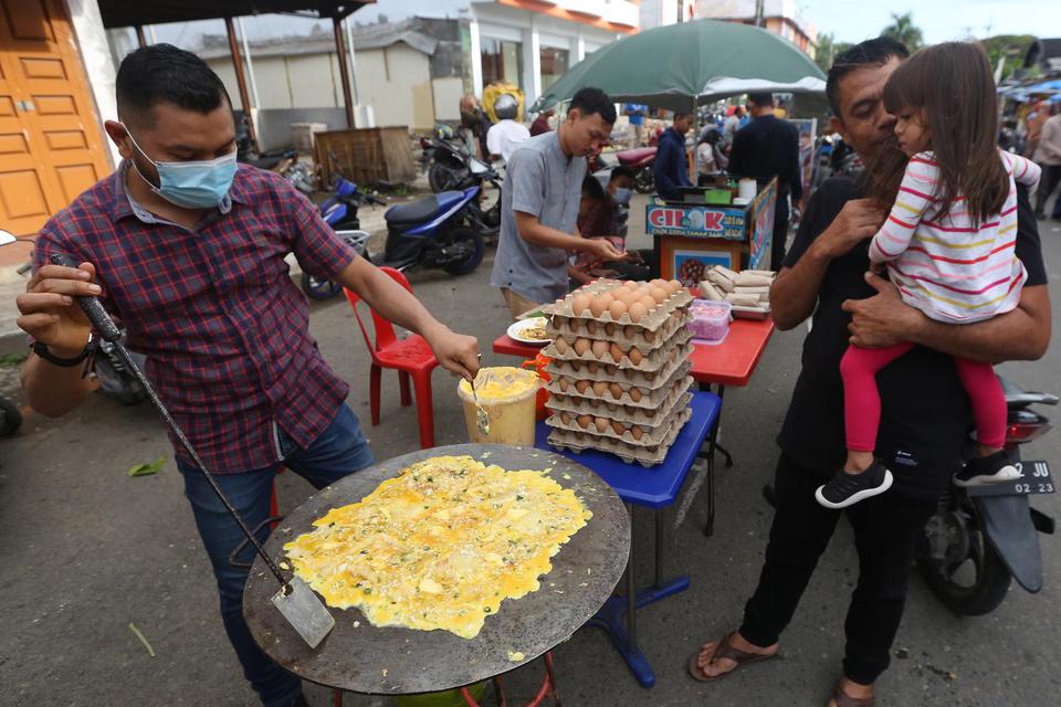 Pedagang memasak makanan khas Aceh, martabak Aceh, untuk menu berbuka puasa yang dijajakan di pasar takjil Ramadhan, Banda Aceh, Aceh, Rabu (14/4/2021). 