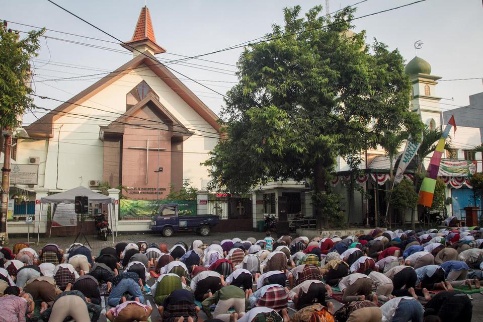 Umat muslim melaksanakan Shalat Idul Fitri 1442 H di Masjid Al Hikmah yang bersebelahan dengan Gereja Kristen Jawa (GKJ) Joyodiningratan, Kratonan, Serengan, Solo, Jawa Tengah, Kamis (13/5/2021). Sebagai bentuk tolaransi umat beragama, Gereja setempat mem