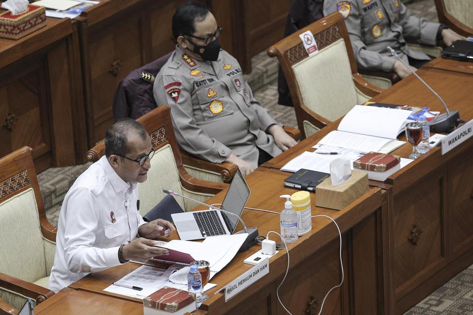 Wakil Menteri Hukum dan HAM Edward Omar Sharif Hiariej (kiri) dan Wakapolri Komjen Pol Gatot Eddy Pramono (kanan) di Kompleks Parlemen, Senayan, Jakarta, Senin (7/6/2021). 