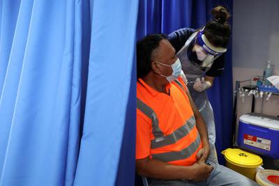 Lim Huey Teng Seorang pekerja konstruksi menerima dosis vaksin penyakit virus korona (COVID-19), Sinovac, di sebuah truk vaksinasi di Kuala Lumpur, Malaysia, Selasa (8/6/2021).