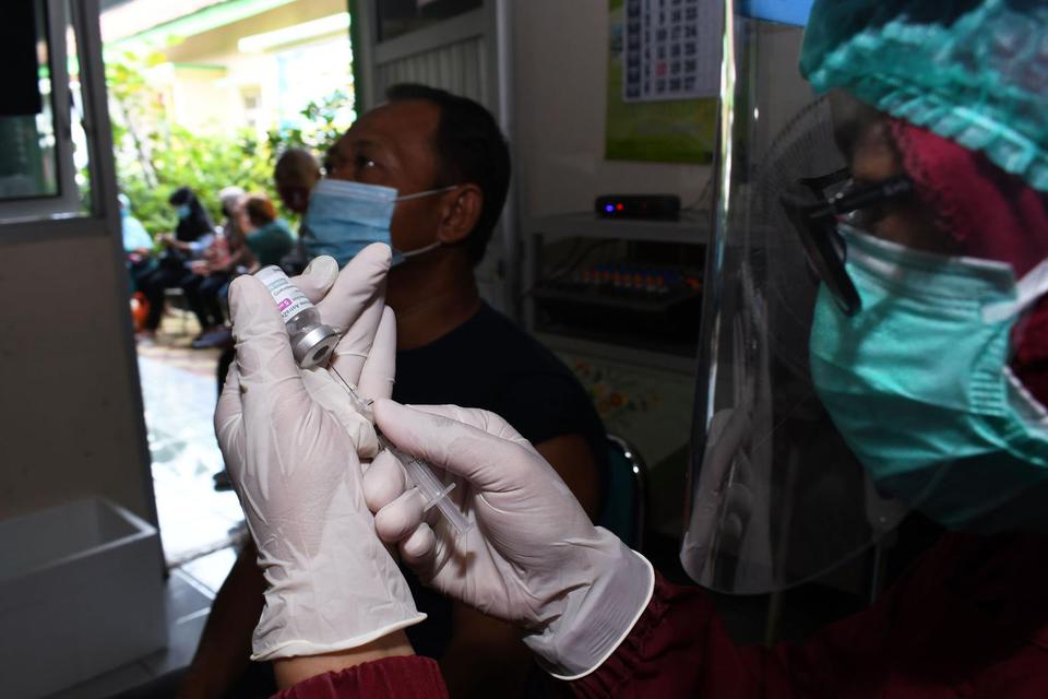 Petugas menyiapkan vaksin COVID-19 AstraZeneca saat vaksinasi bagi warga lanjut usia (lansia) dan pedagang pasar di balai Kelurahan Nambangan Lor, Kota Madiun, Jawa Timur, Rabu (9/6/2021). Vaksinasi bagi warga lansia dan pedagang pasar tersebut dimaksudka