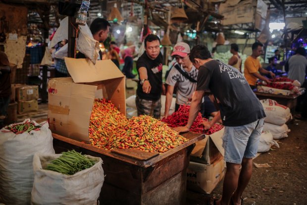 Pedagang cabai rawit di melayani pembeli lapak miliknya di Pasar Induk Kramat Jati, Jakarta, Selasa (28/12/2021). Pangsa pasar adalah persentase nilai jual atau beli barang atau jasa tertentu yang dikuasai oleh pelaku usaha pada pasar bersangkutan dalam t
