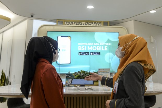 Petugas melayani nasabah melalui tablet saat bertransaksi di kantor pusat Bank Syariah Indonesia di Jakarta, Selasa (11/1/2022). Wakalah adalah akad pemberian kuasa dari muwakkil kepada wakil untuk melakukan perbuatan hukum tertentu. Wakalah diatur dalam 