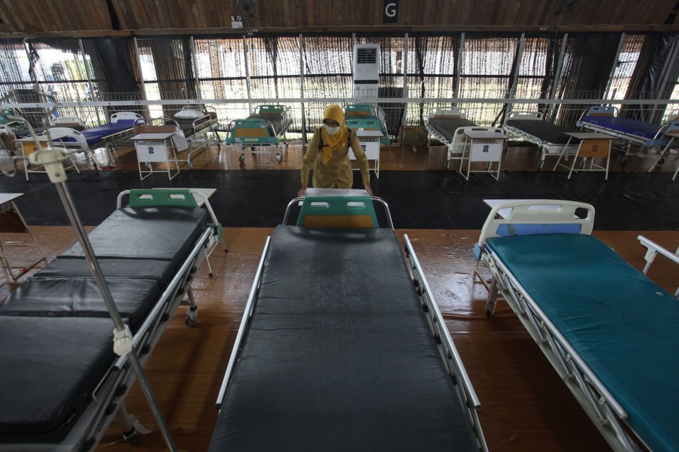Petugas menata meja di dekat tempat tidur pasien di Rumah Sakit Lapangan Tembak, Surabaya, Jawa Timur, Senin (7/2/2022). Pemkot Surabaya mengoperasikan kembali rumah sakit darurat COVID-19 tersebut sebagai isolasi terpusat bagi pasien yang terkonfirmasi p