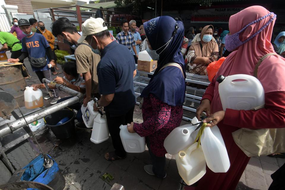 Warga antre membeli minyak goreng curah dalam Pasar Murah Festival Ramadhan di halaman Masjid Baitul Makmur, Denpasar, Bali, Kamis (31/3/2022). 