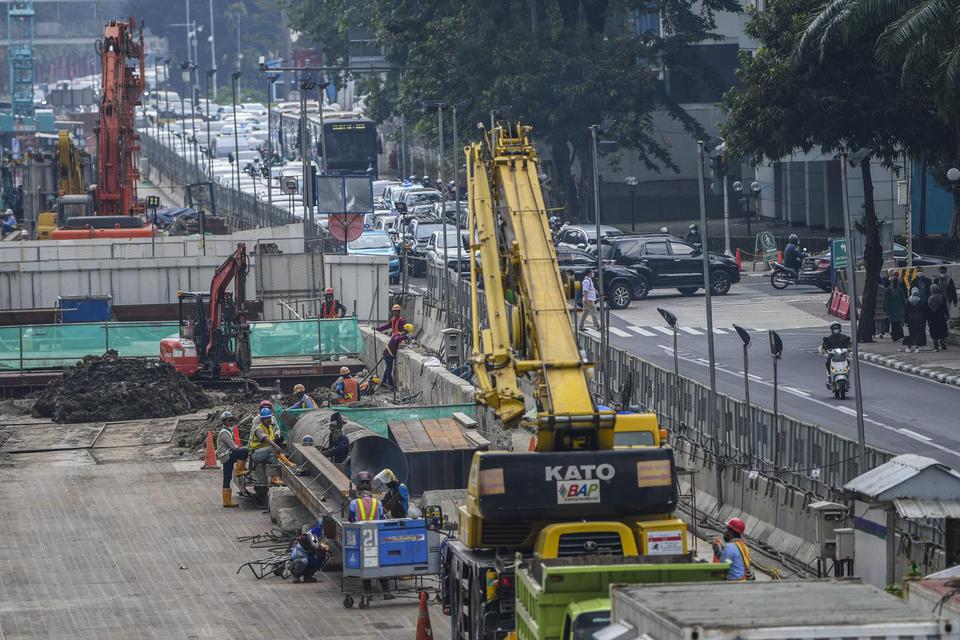 Sejumlah pekerja menyelesaikan proyek Moda Raya Terpadu (MRT) Fase II di Jalan MH Thamrin, Jakarta, Rabu (13/7/2022).
