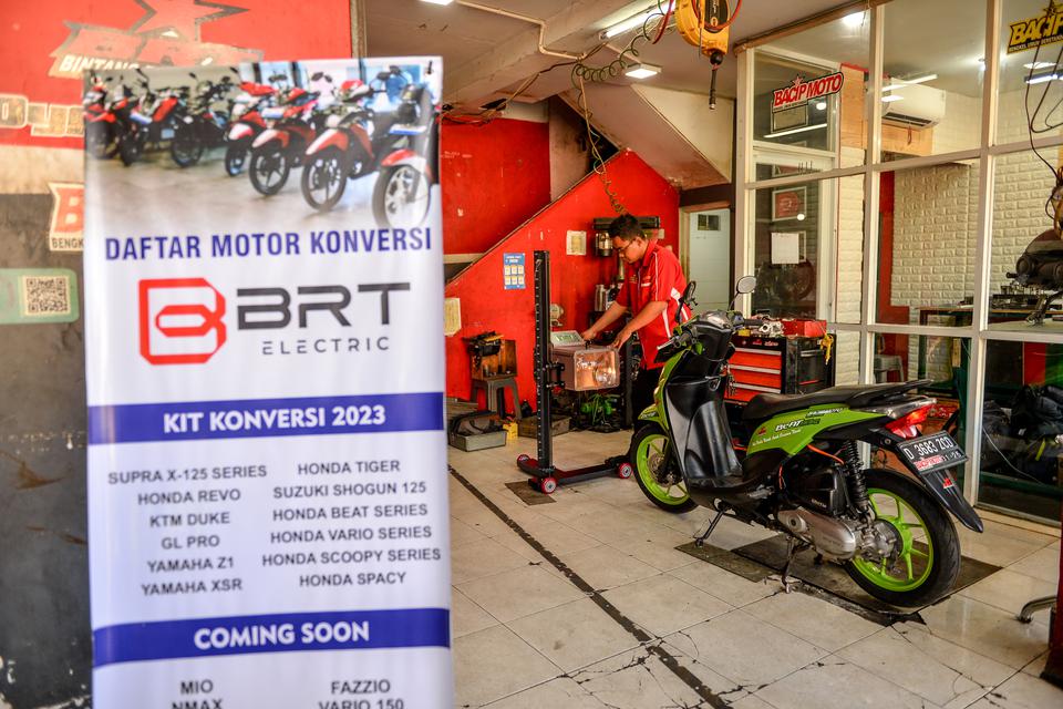 Mekanik melakukan pengujian intensitas cahaya lampu motor bbm yang dikonversi ke motor listrik di bengkel Bacip Moto Shop di Bandung, Jawa Barat, Senin (3/7/2023). Bengkel Bacip Moto Shop binaan Bintang Racing Team tersebut merupakan bengkel resmi pemasan