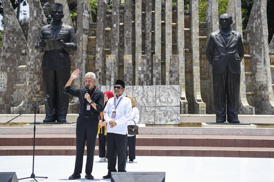 Bakal calon presiden dari PDI Perjuangan Ganjar Pranowo (kiri) dan bakal calon wakil presiden Mahfud MD (kanan) menyampaikan pidato politiknya sebelum menuju KPU dari Tugu Proklmasi di Jakarta, Kamis (19/10/2023). 