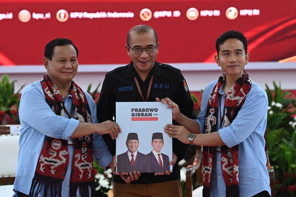 Ketua KPU Hasyim Asy'ari (tengah) menerima berkas pendaftaran pencalonan dari pasangan bakal calon presiden dan wakil presiden Prabowo Subianto (kiri) dan Gibran Rakabuming Raka (kanan) di Kantor KPU Pusat, Jakarta, Rabu (25/10/2023).