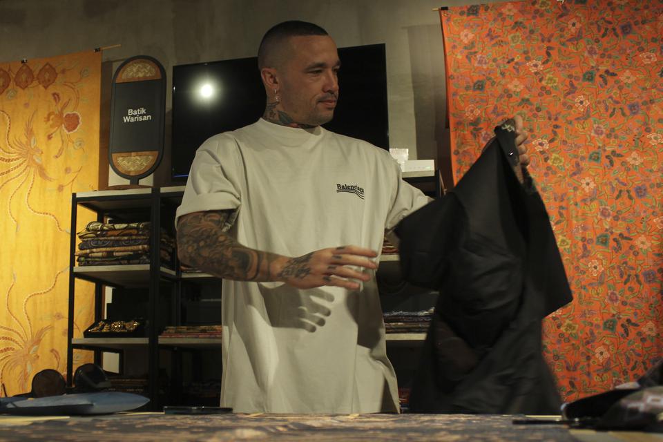 Mantan pemain AS Roma, Radja Nainggolan mencoba batik yang hendak dibeli di Sarinah, Jakarta, Selasa (7/11/2023).
