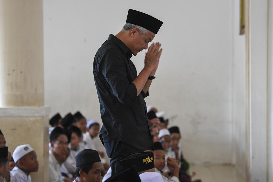 Calon presiden nomor urut 3 Ganjar Pranowo (tengah) menjalankan shalat sunah di Pondok Pesantren Syaichona Cholil, Balikpapan, Kalimantan Timur, Selasa (5/12/2023).