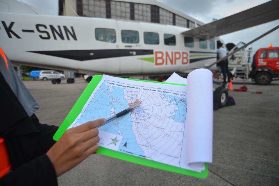 Tim Saintis penerbangan Smart Aviation menunjukan wilayah yang memiliki awan hujan usai menabur garam untuk modifikasi cuaca di Bandara Internasional Minangkabau (BIM) Padang Pariaman, Sumatera Barat, Rabu (15/5/2024). Tim penabur menaburkan 2 ton garam p