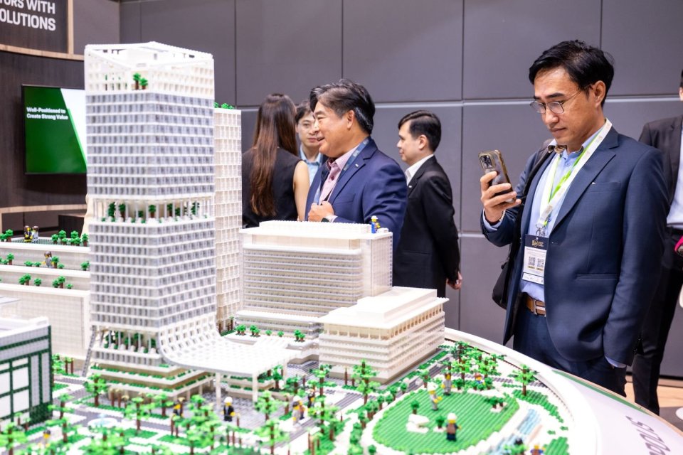 Seorang pengunjung mengambil gambar model properti ramah lingkungan pada World Cities Summit Exhibition di Singapura, Selasa (4/6).
