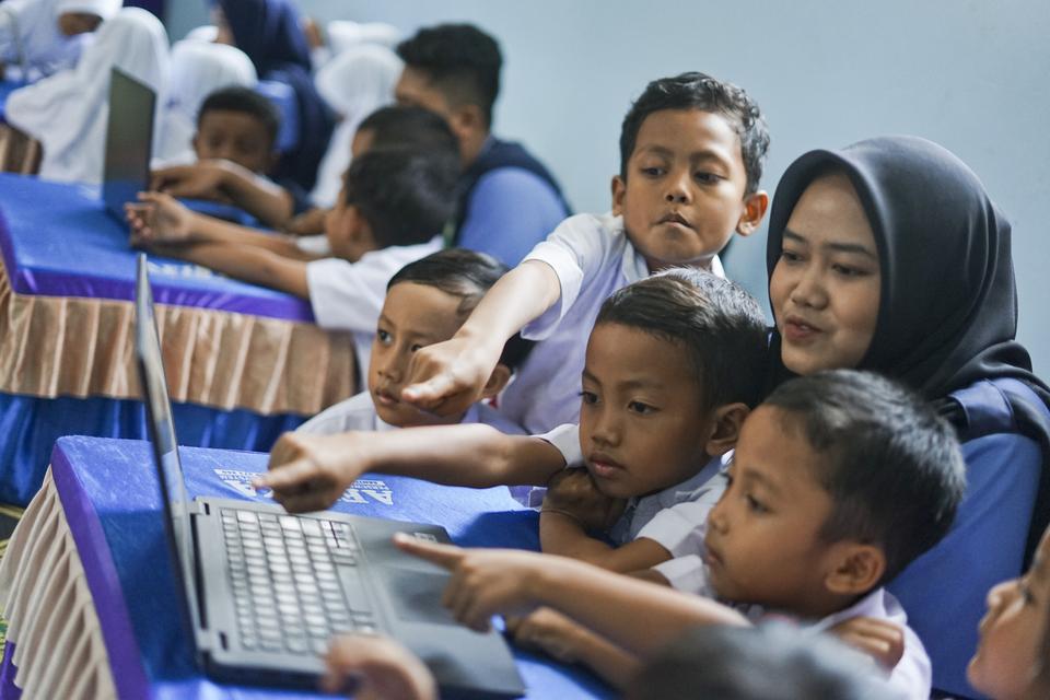 Sejumlah pelajar melihat video edukasi pelajaran melalui kanal youtube saat peluncuran layanan internet desa di Desa Banteng, Tersono, Kabupaten Batang, Jawa Tengah, Kamis (8/8/2024).