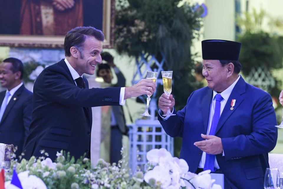 Presiden Prabowo Subianto (kanan) bersama Presiden Prancis Emmanuel Macron (kiri) bersulang saat jamuan makan malam di Istana Negara, Jakarta, Rabu (28/5/2025). 