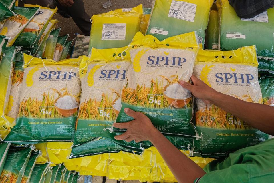 Petugas Bulog menata beras SPHP saat gerakan pasar murah Bulog dan Polda Sultra di pelataran Eks MTQ, Kendari, Sulawesi Tenggara, Rabu (6/8/2025). Perum Bulog mencatat sebanyak 18,3 juta jiwa menjadi sasaran penerima manfaat penyaluran program bantuan pan
