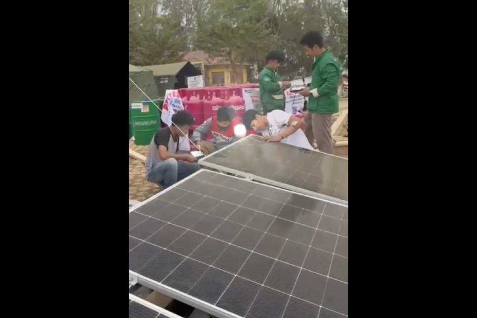 Petugas memasang Pembangkit Listrik Tenaga Surya (PLTS) bantuan Pertamina di posko pengungsian Aceh Tamiang.
